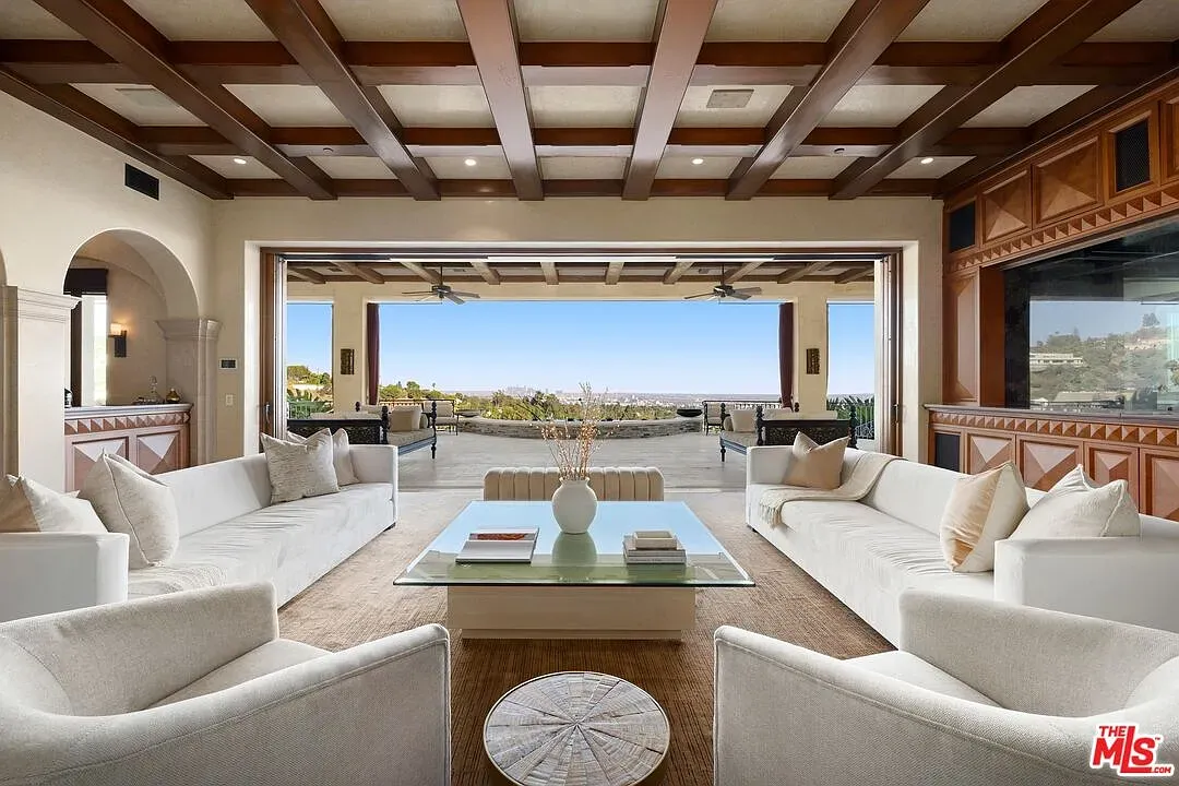 Living room opens wide. dark coffered ceiling. Not sure with that view, though.