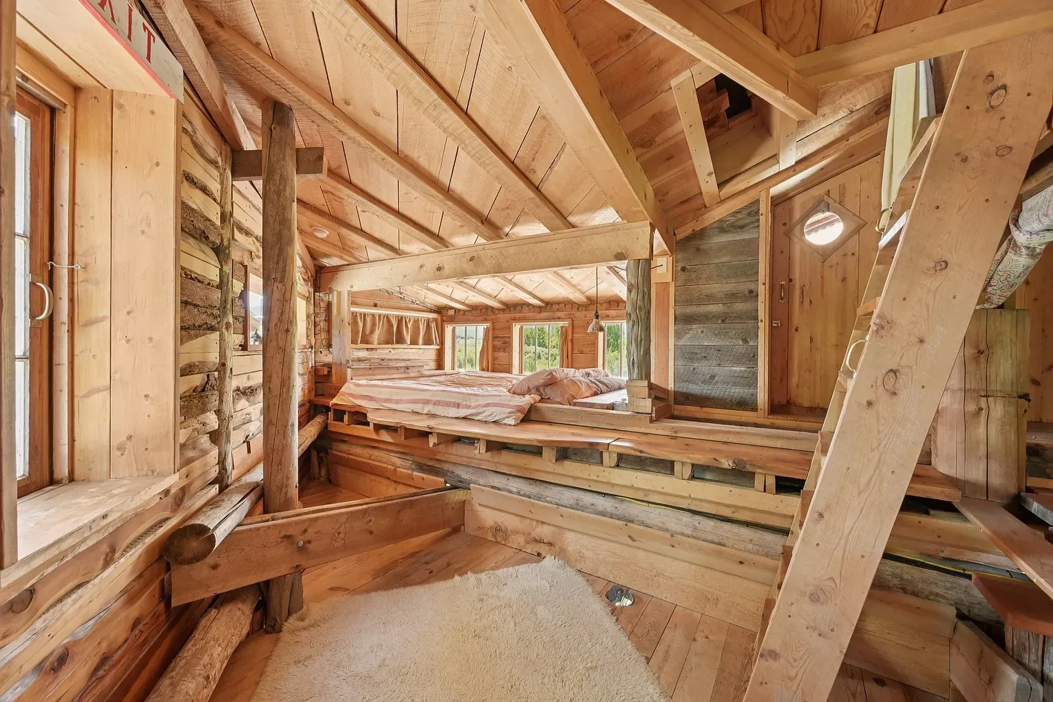 Loft nook under big beams. Looks quiet, warm, probably smells cedar.