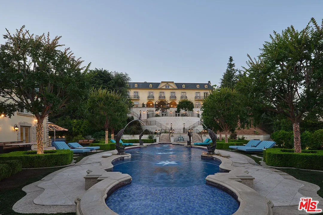 From this angle, twilight makes the chateau vibes hit harder. Garden spreads forever.