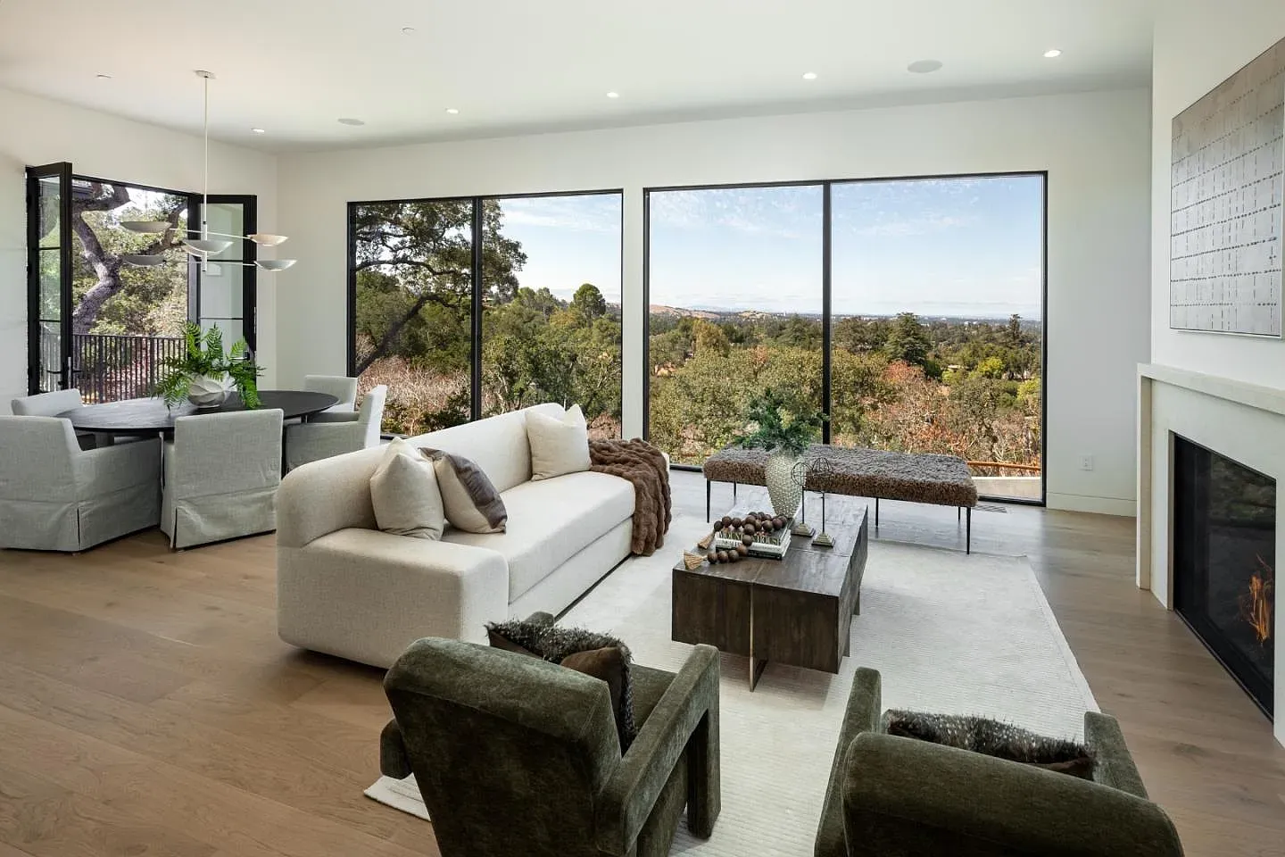 Floor-to-ceiling windows and green hills. The living room basically lives outside.