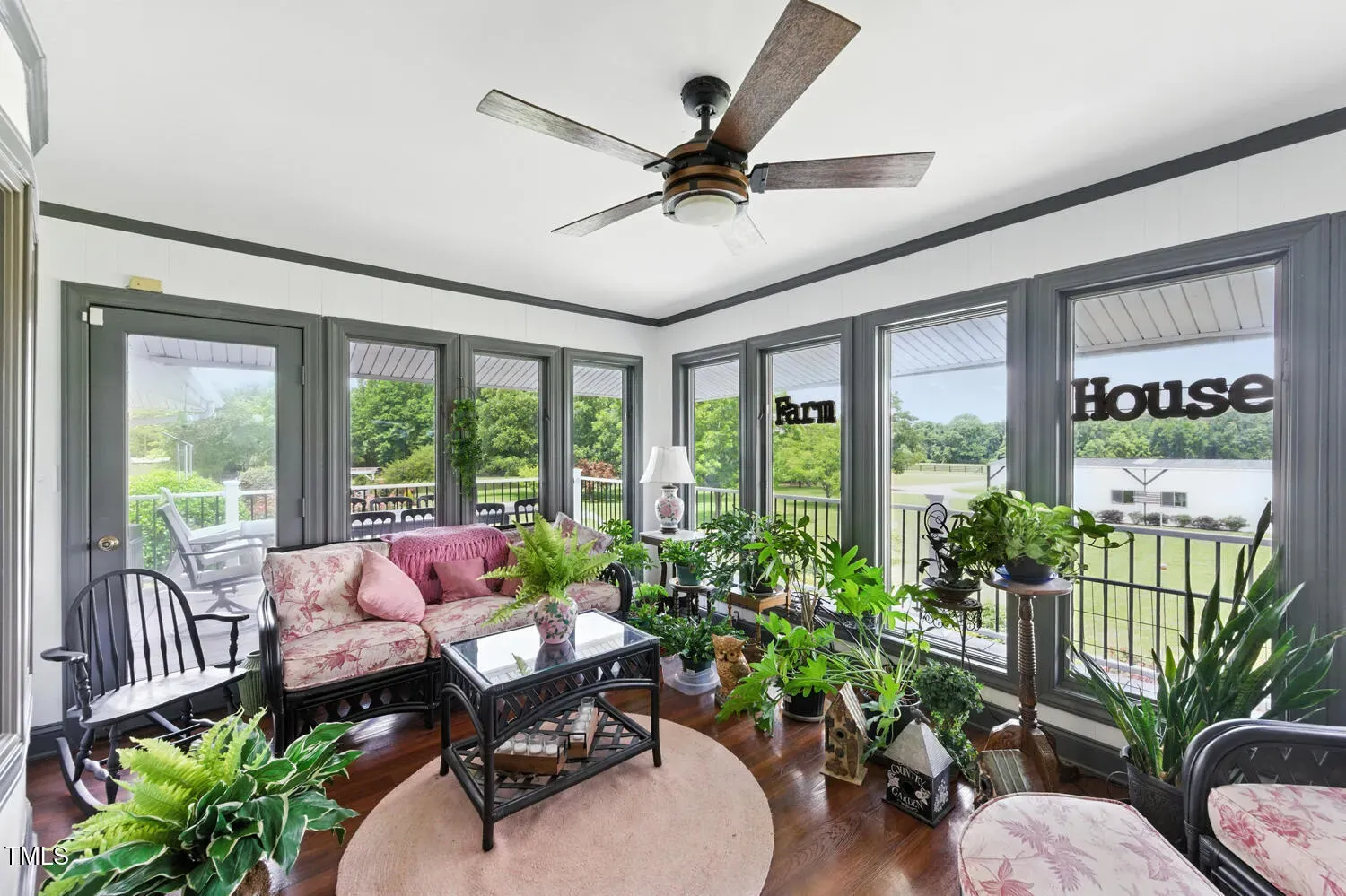 Sunroom’s all windows and soft tones. Plants would go feral in here.