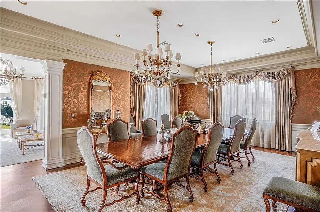 Formal dining goes dramatic wood with green chairs. Fancy, but inviting.