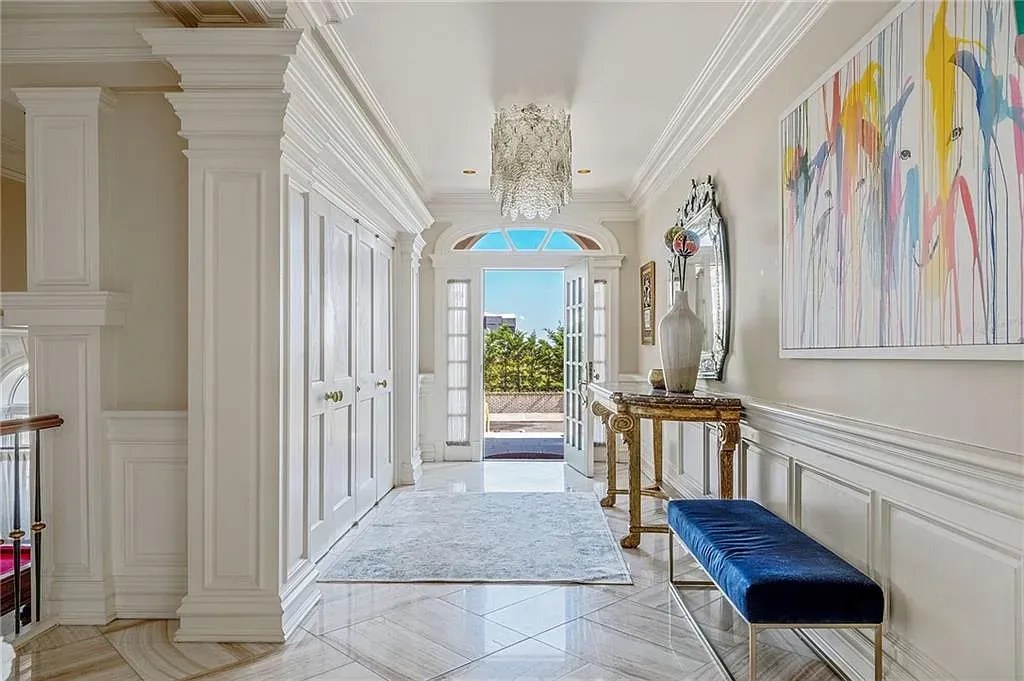 Entryway’s all cream with chunky crown molding. Classic first impression.