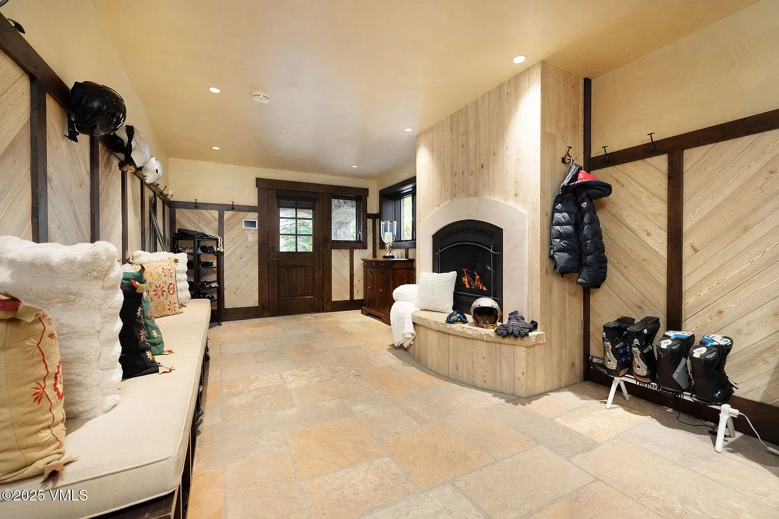 Mudroom/ski room. wood, stone, lots of hooks. Practical, toasty vibe.