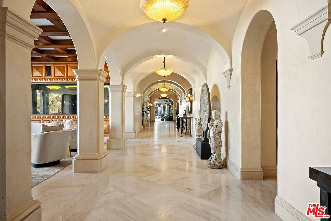 Hallway goes cathedral mode—arches, golden glow, fancy lights. Echoes included.