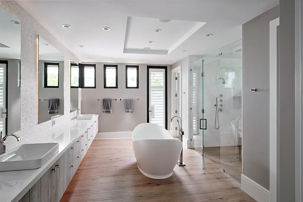 Freestanding tub moment. Wood floors make it feel spa-y without being cold.