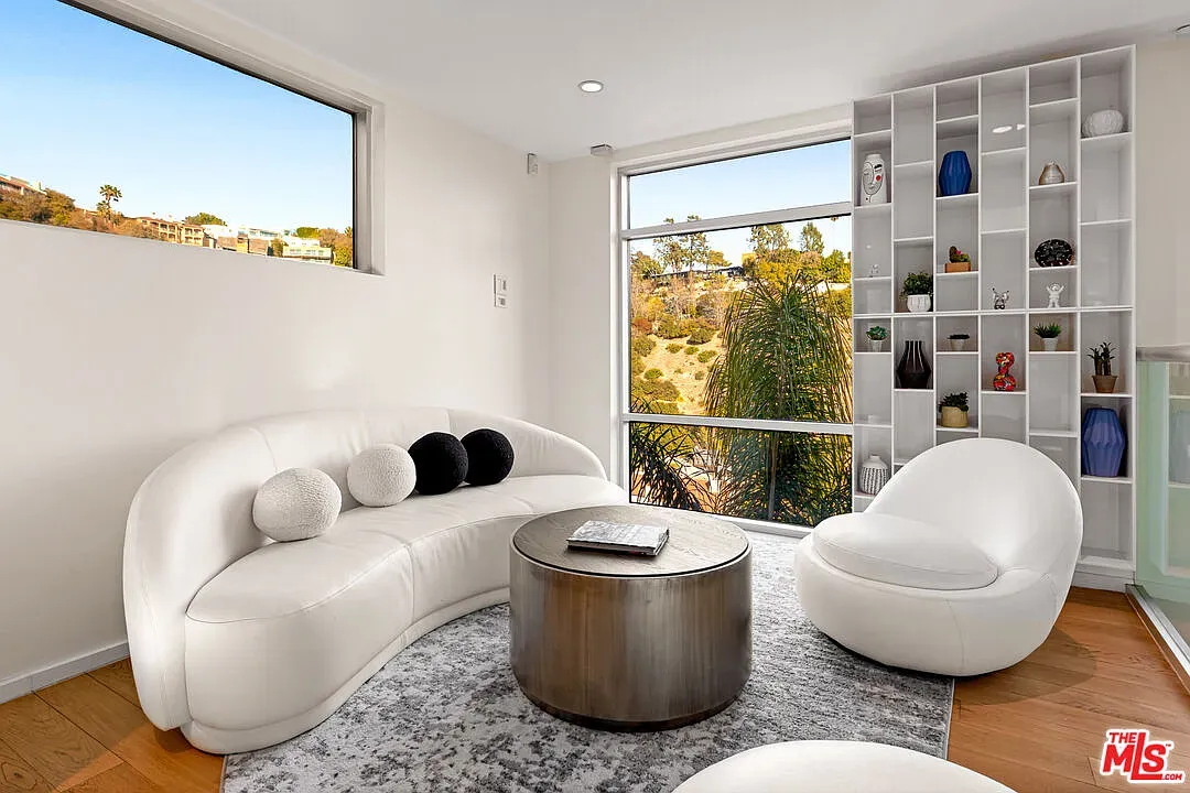 Curvy white sofa looks ridiculously comfy. Textured pillows do the heavy lifting.