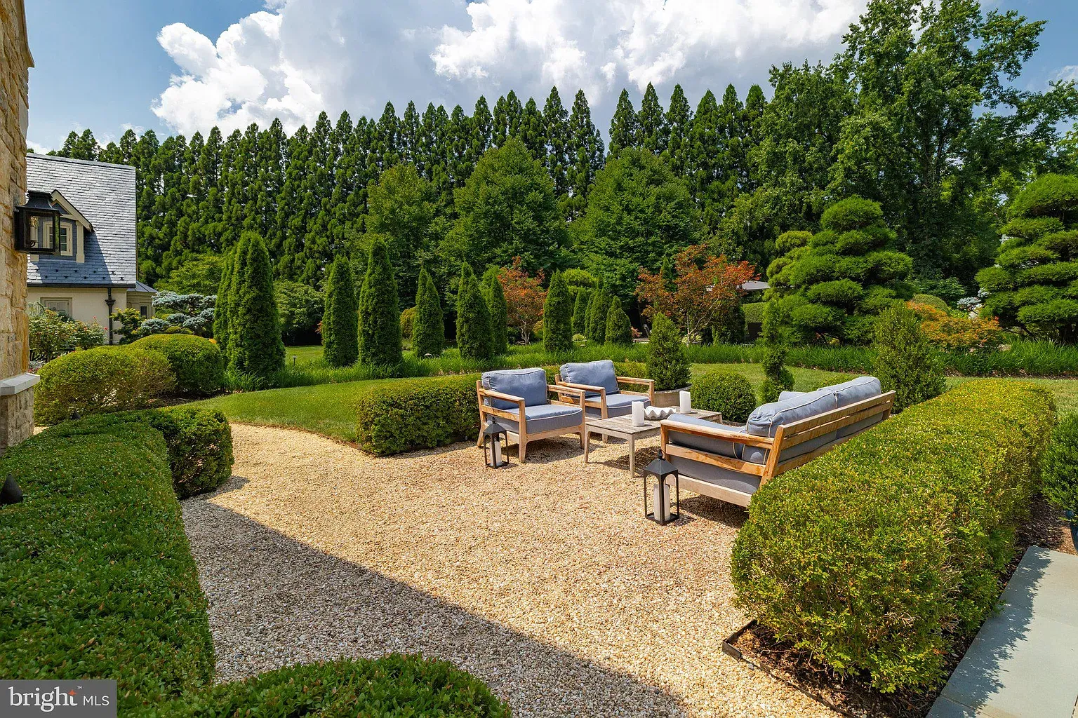 Garden ringed by evergreens. Quiet, very put-together.