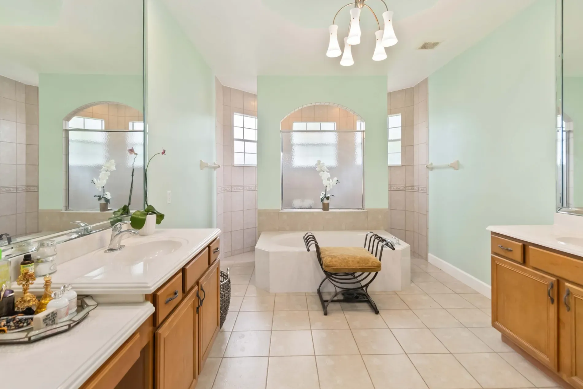 Mint walls and a soaking tub in a curve—spa day energy.