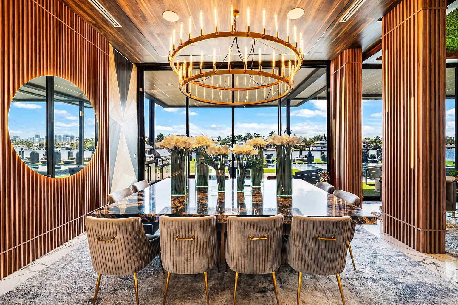 Formal dining flex. marble table, velvet chairs, gold sparkle overhead.