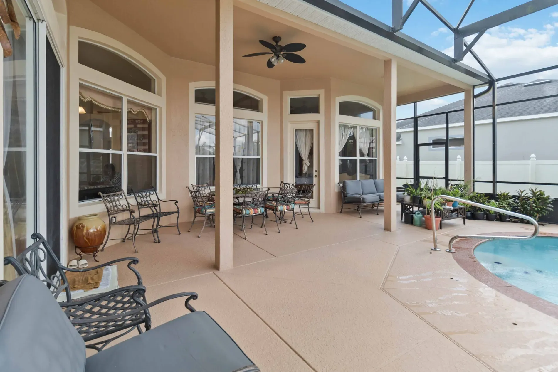 And then the patio—arched windows, beige ceiling, indoor-outdoor flow for days.