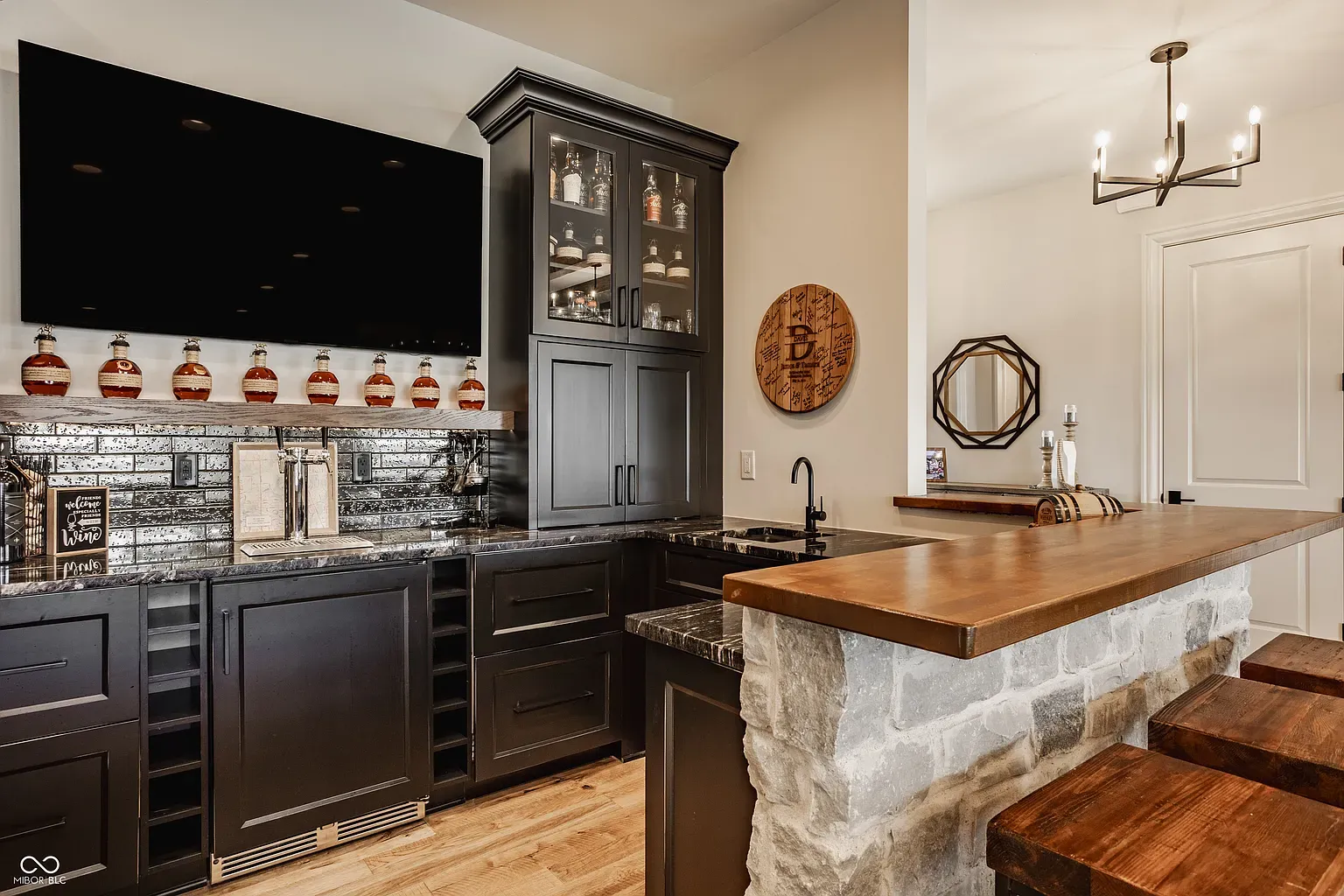 Sleek bar moment. Glass doors show off the collection a museum.