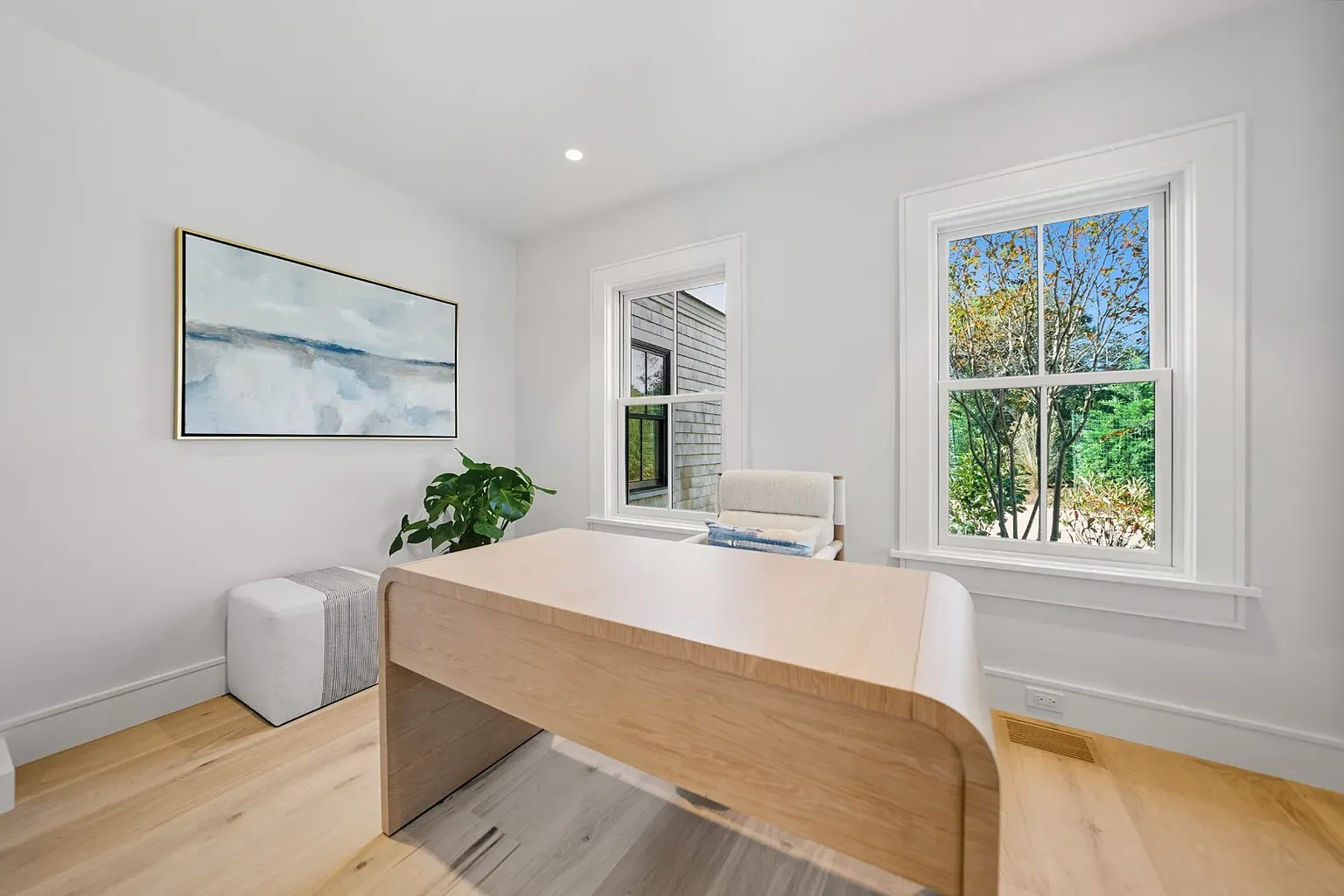 Calm office—white on white, sunlight blasting, light floors keeping it warm.