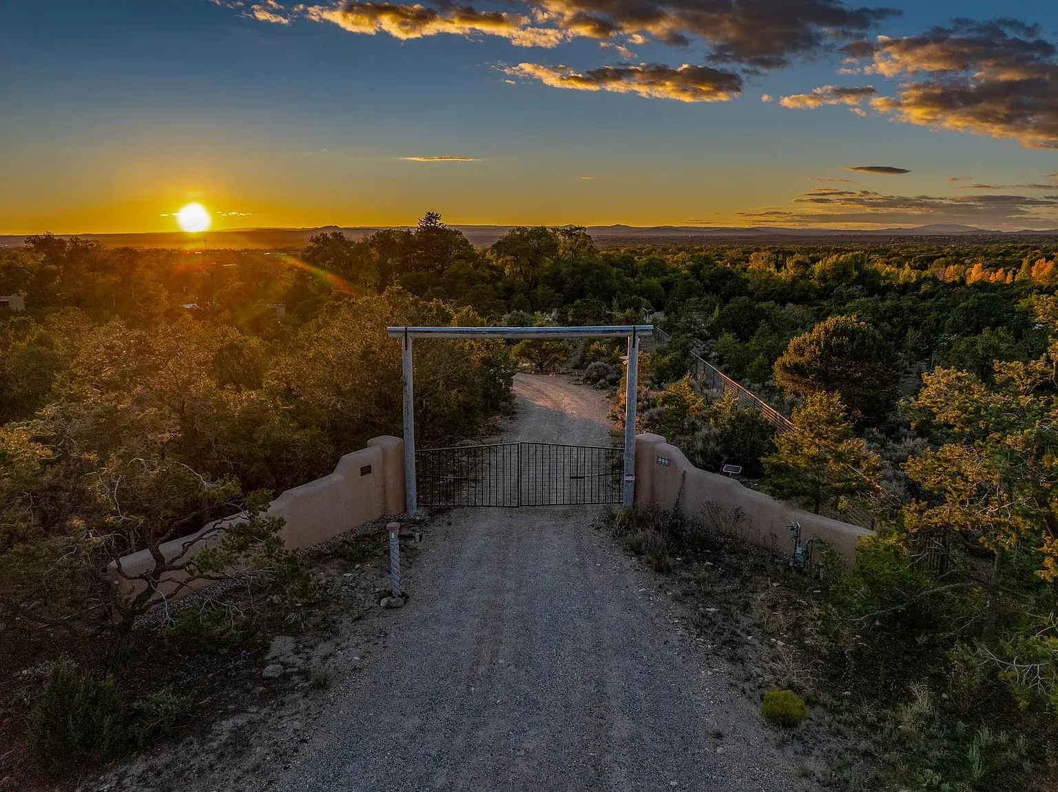 Sunset through the wooden arch gate. Crunchy gravel soundtrack.