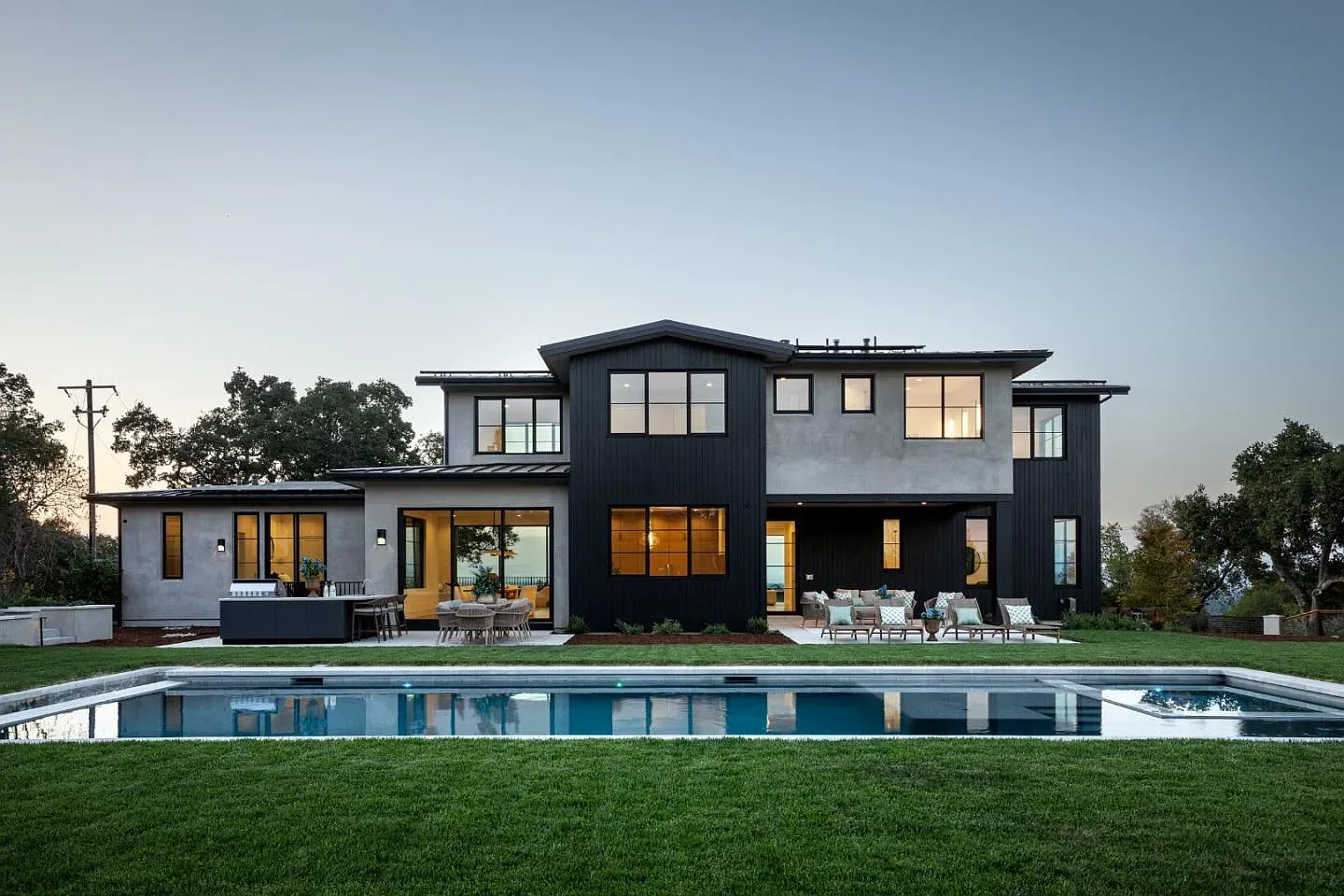 Mixed materials outside. dark wood next to light stucco, big windows. Sharp.