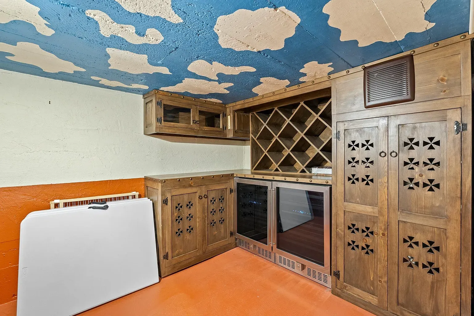 Wine closet with a sky ceiling. Tiny, weird, delightful.