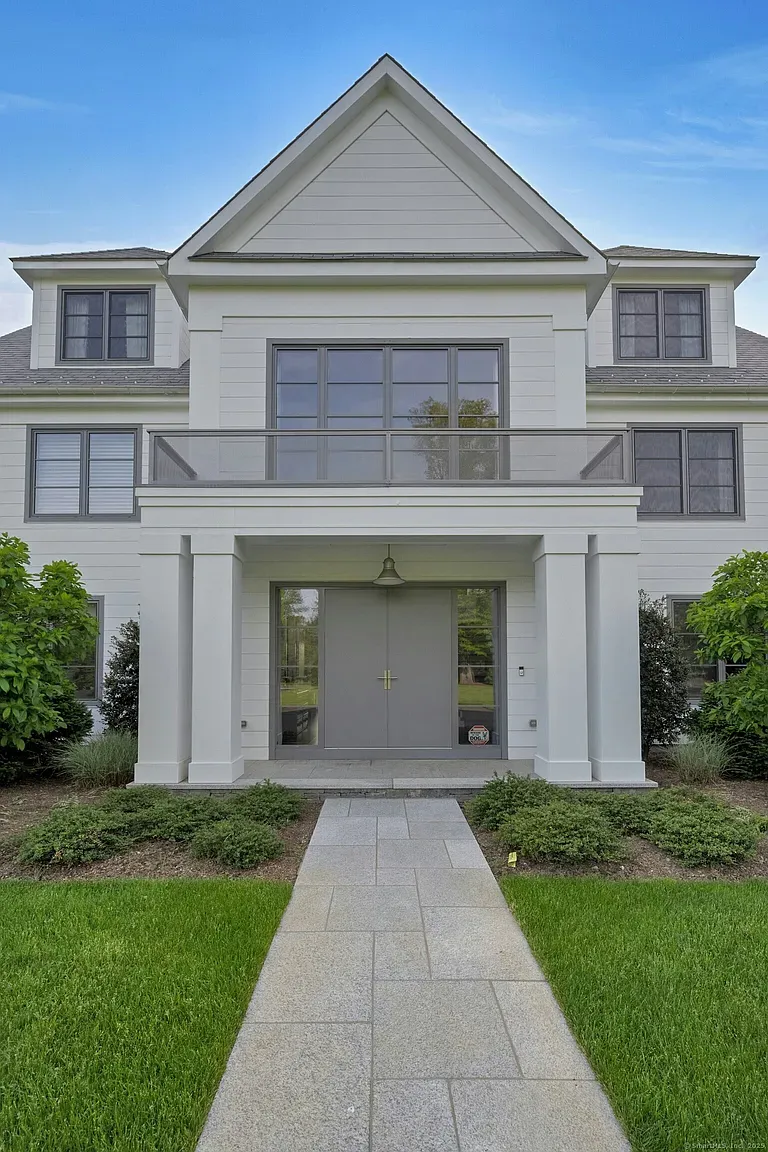 Okay, this facade—super symmetrical, steep gable, soft white and calm grays.