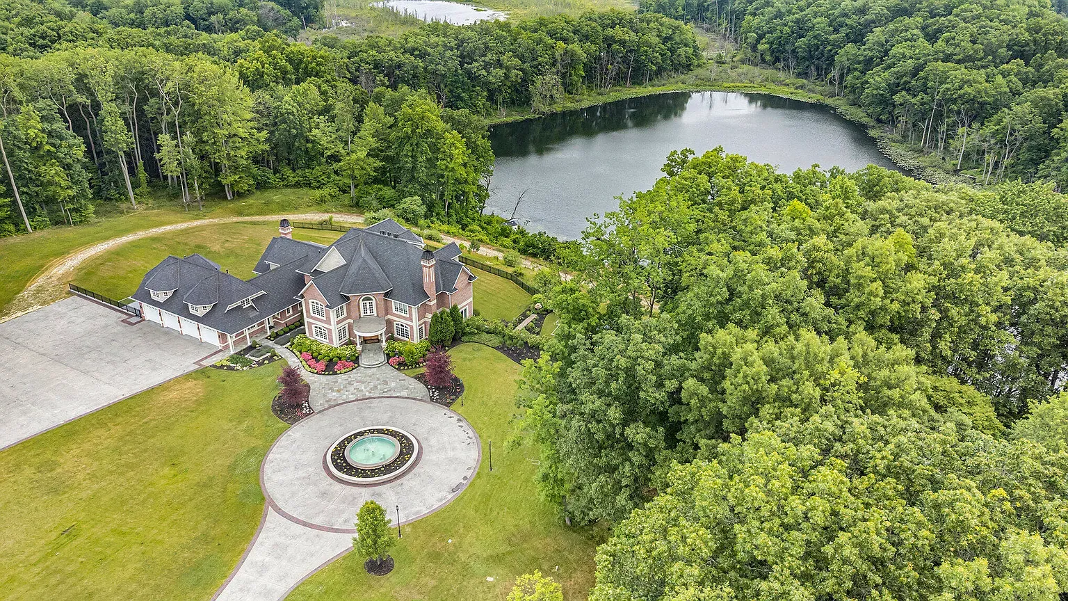 Back-of-house flex. gables, stone, and that lake stealing the show.