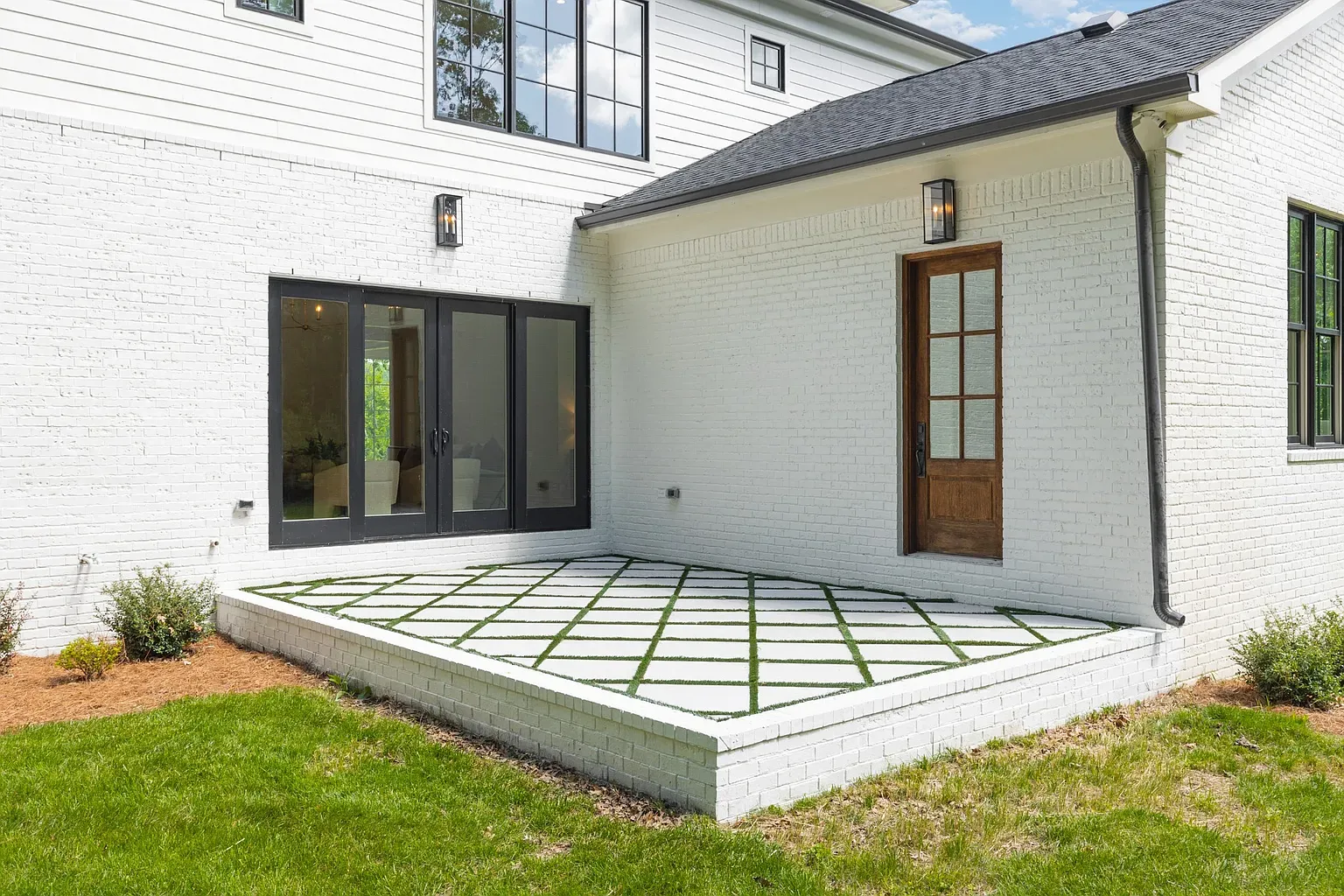 Indoor-outdoor moment. Black sliders, white brick, easy hangout zone.