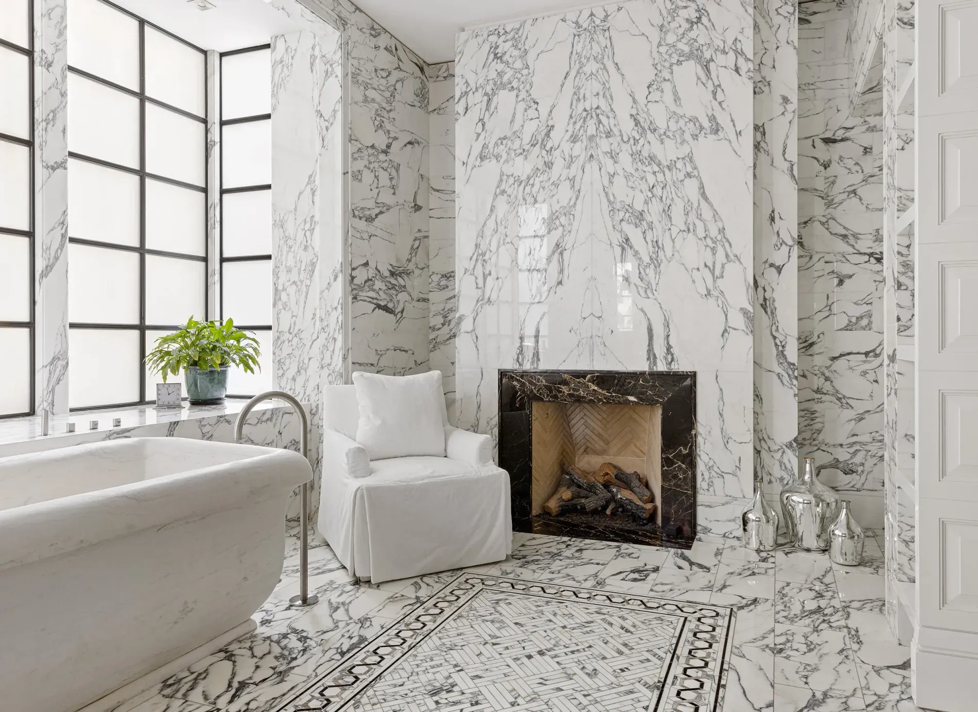 Sunlit marble bathroom. Big windows, everything gleams.