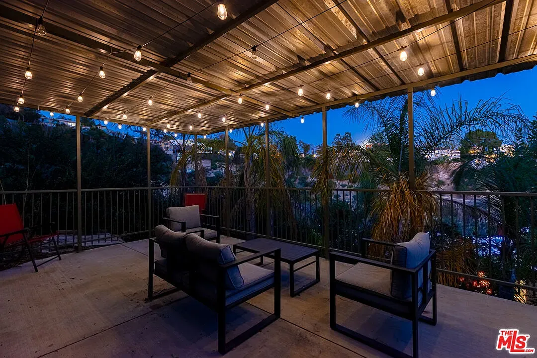 Little covered terrace with string lights. Corrugated roof gives it cabin-meets-industrial.