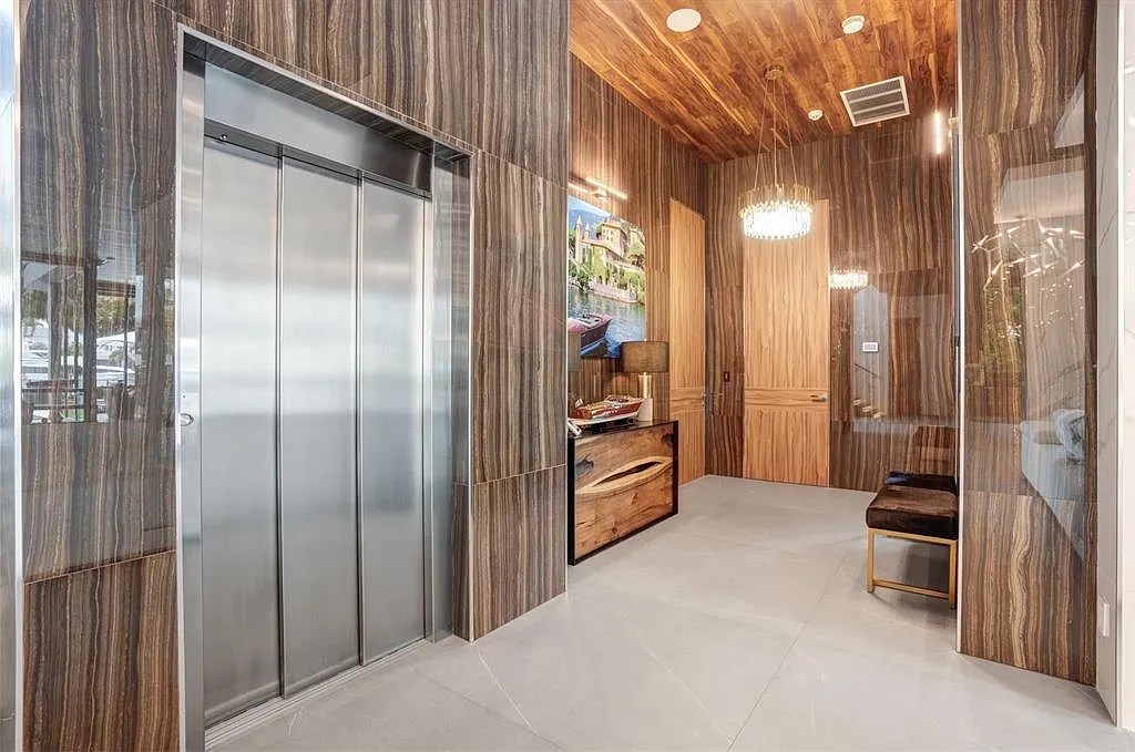 Elevator lobby flex. Warm wood panels and that striped ceiling feel fancy but cozy.