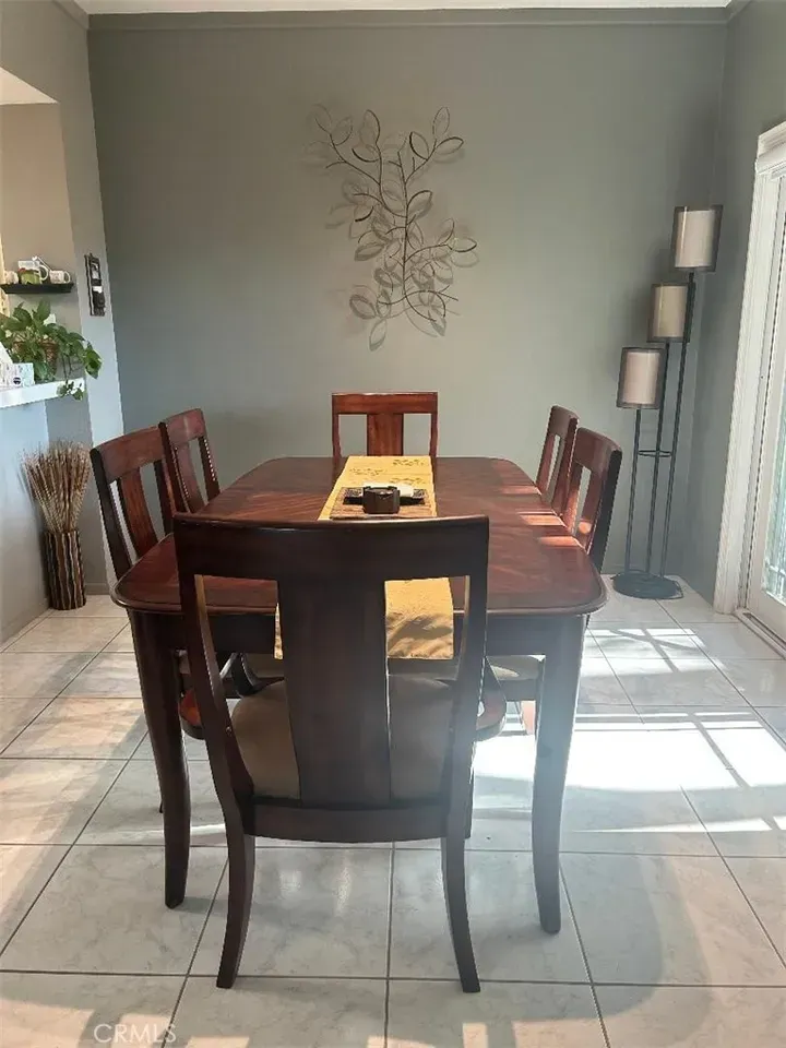 Big table energy—dark wood, six chairs, cream cushions. Who seats six daily?