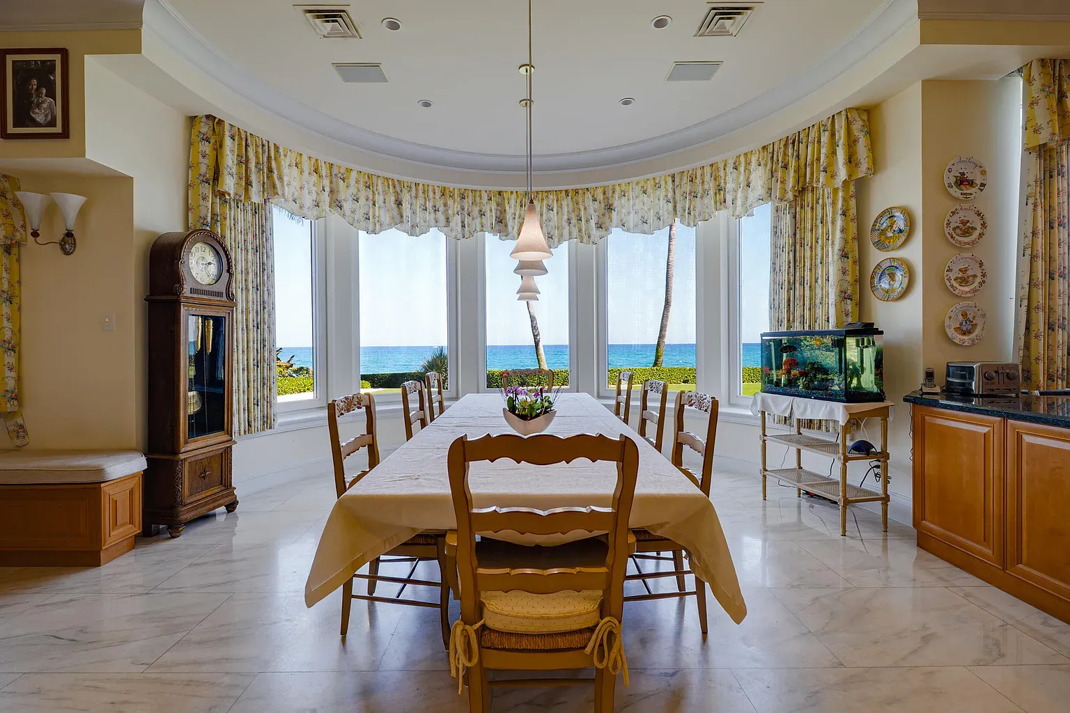 Bright dining with bay windows and floral drapes. Ocean views doing overtime.