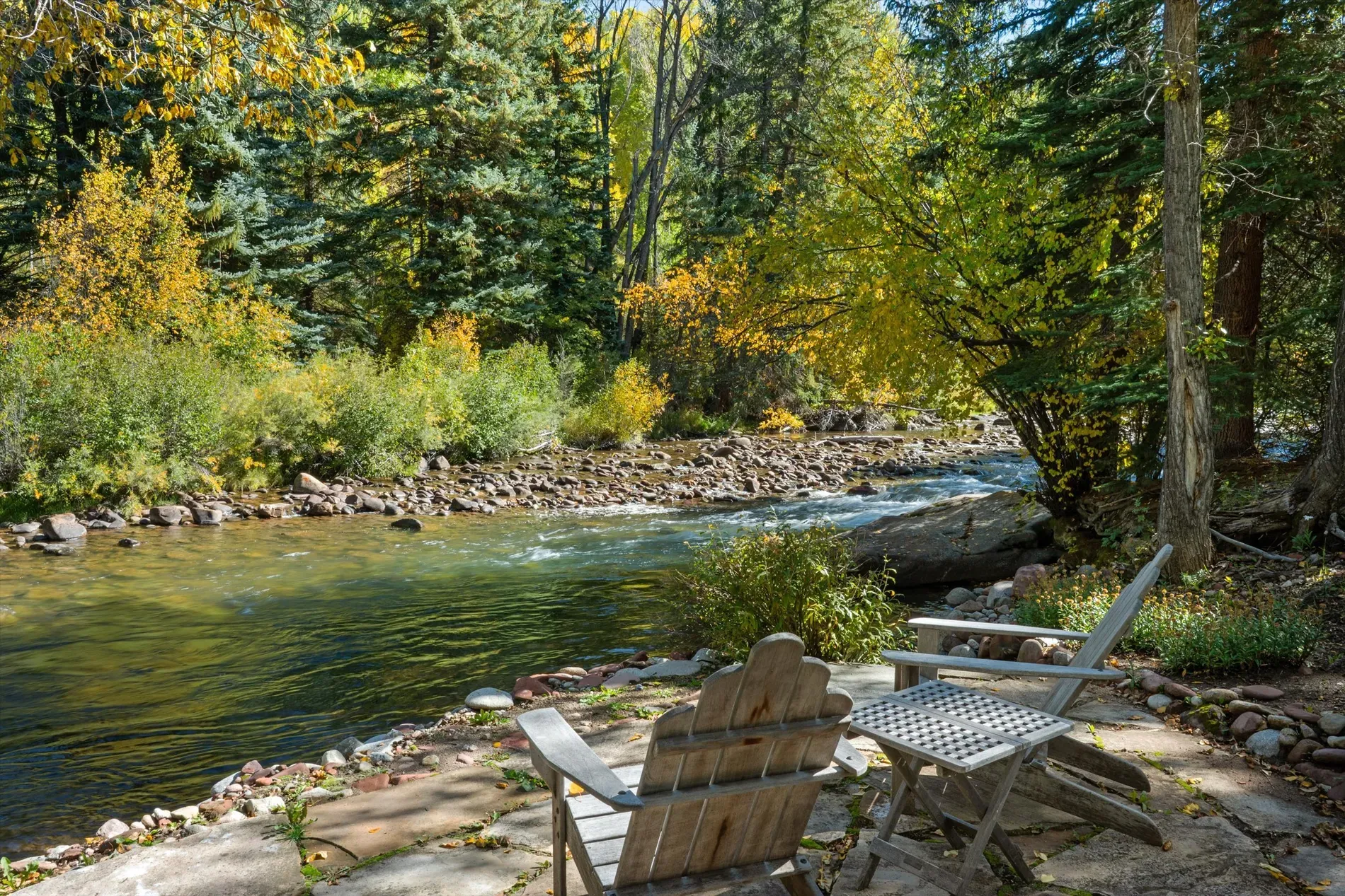Back outside — stone patio right on the river. Sounds white noise.