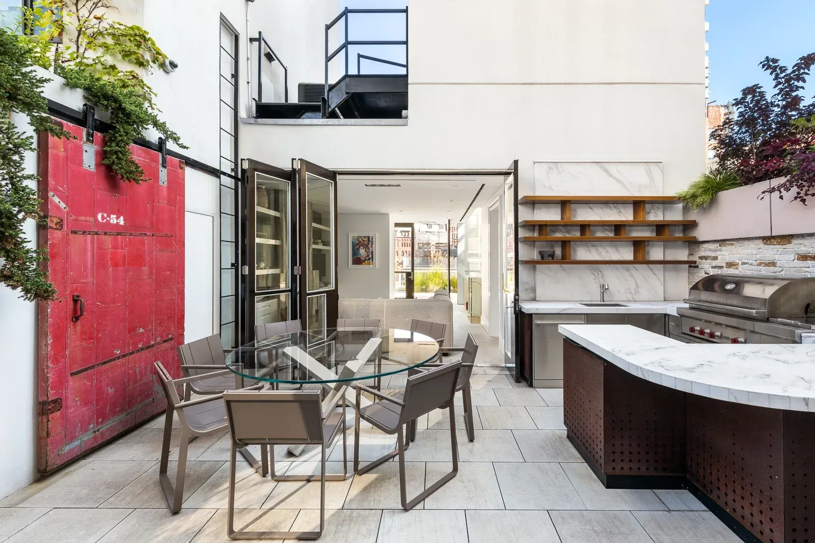 Back outside—patio dining, glass table, metal chairs. Looks ready for brunch.