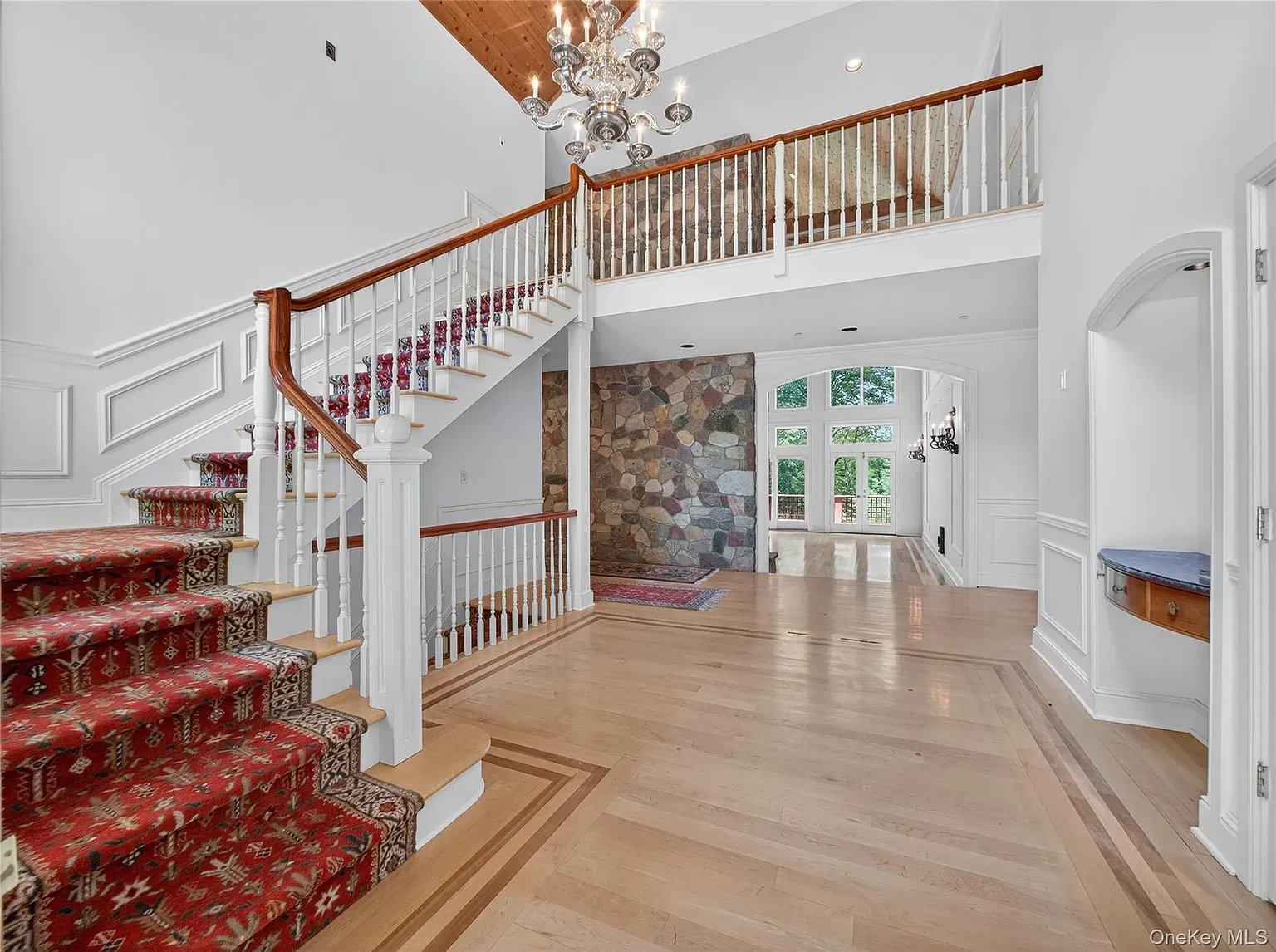 Not subtle. Twin staircases with red carpet rolling straight at you.