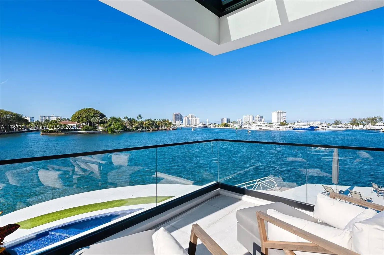 Balcony with glass railing right over the water. Yep, sunsets live here.