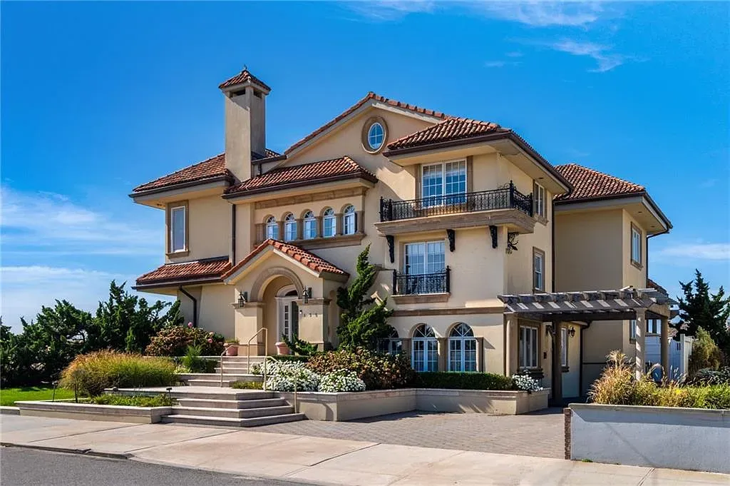 Here's the facade — sandy stucco, terracotta roof. Warm and pretty.