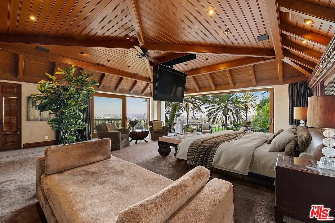 Bedroom under beams with massive windows. Anyone know why the bed’s so tiny?