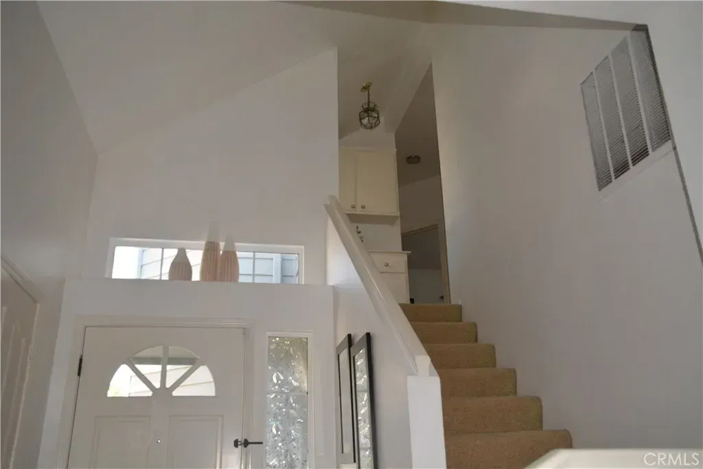 And then the entry—tall sloped ceiling, crisp white walls. Kinda airy, echo-y.