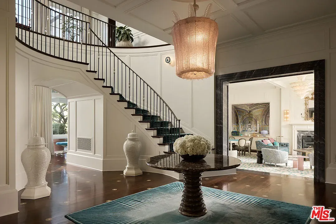 Here’s the spiral staircase moment. Dark treads look sharp against pale walls.