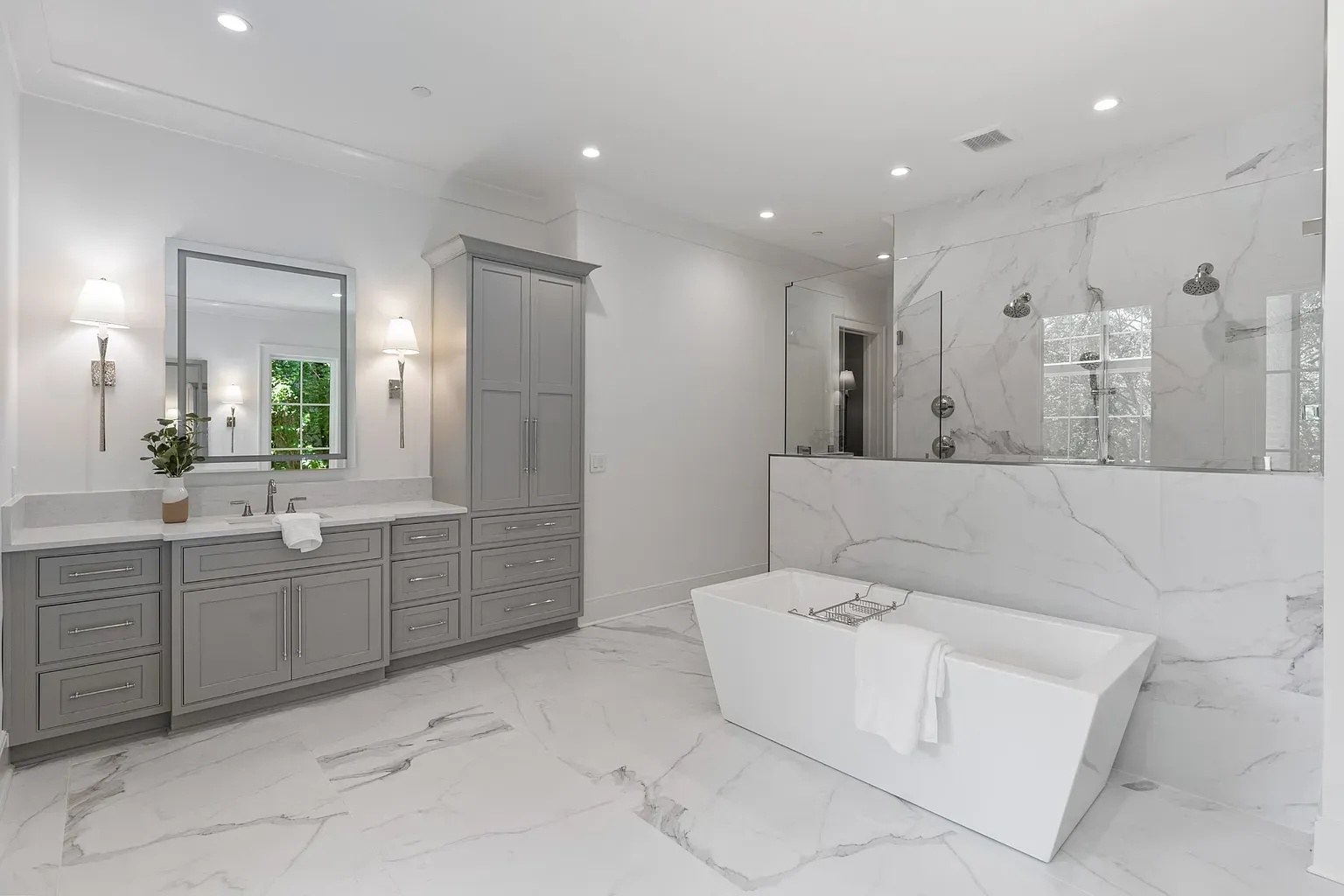 Spa bathroom energy. Big marble everywhere, calm whites and grays.
