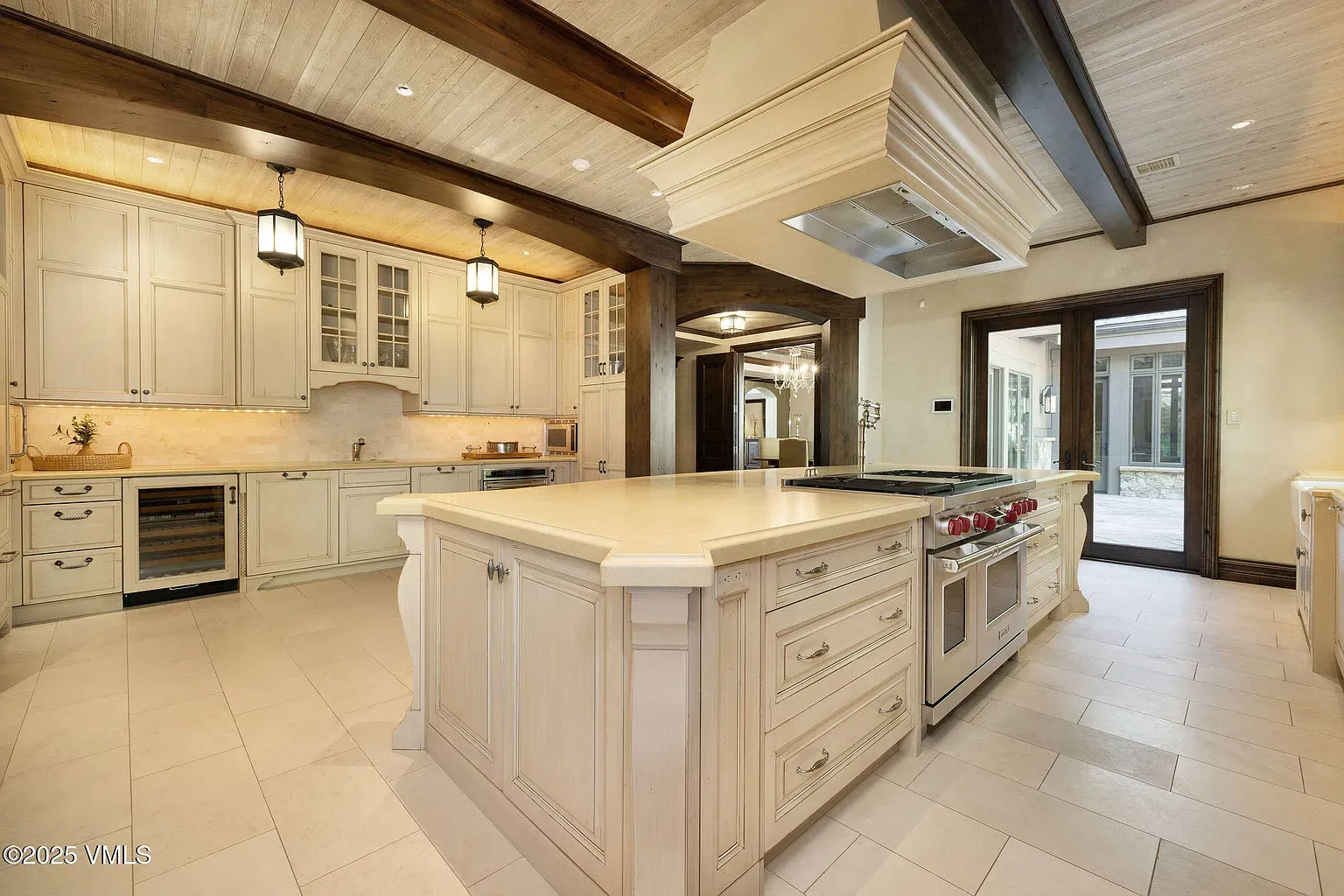 Here's the kitchen. big creamy island, detailed cabinets. Fancy but workable?