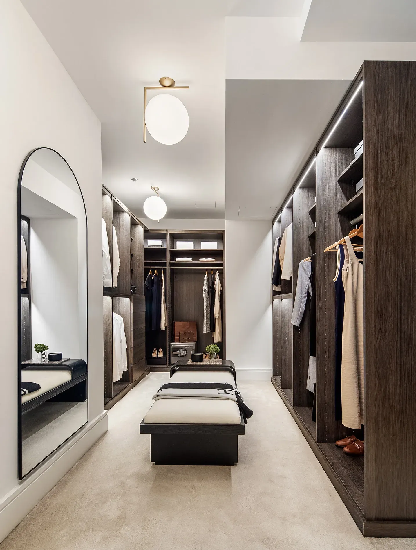 Here's the closet—soft neutrals plus dark wood. Looks organized, maybe a bit hotel-y.