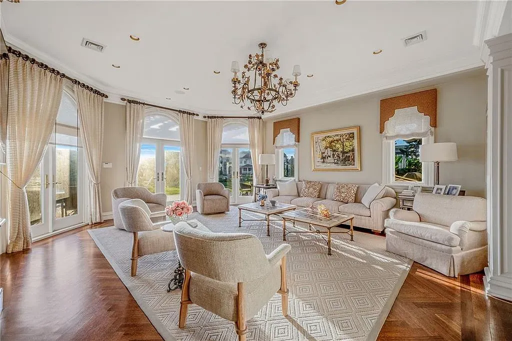 Living room is beige-on-beige, glass coffee table. Calm hotel energy.