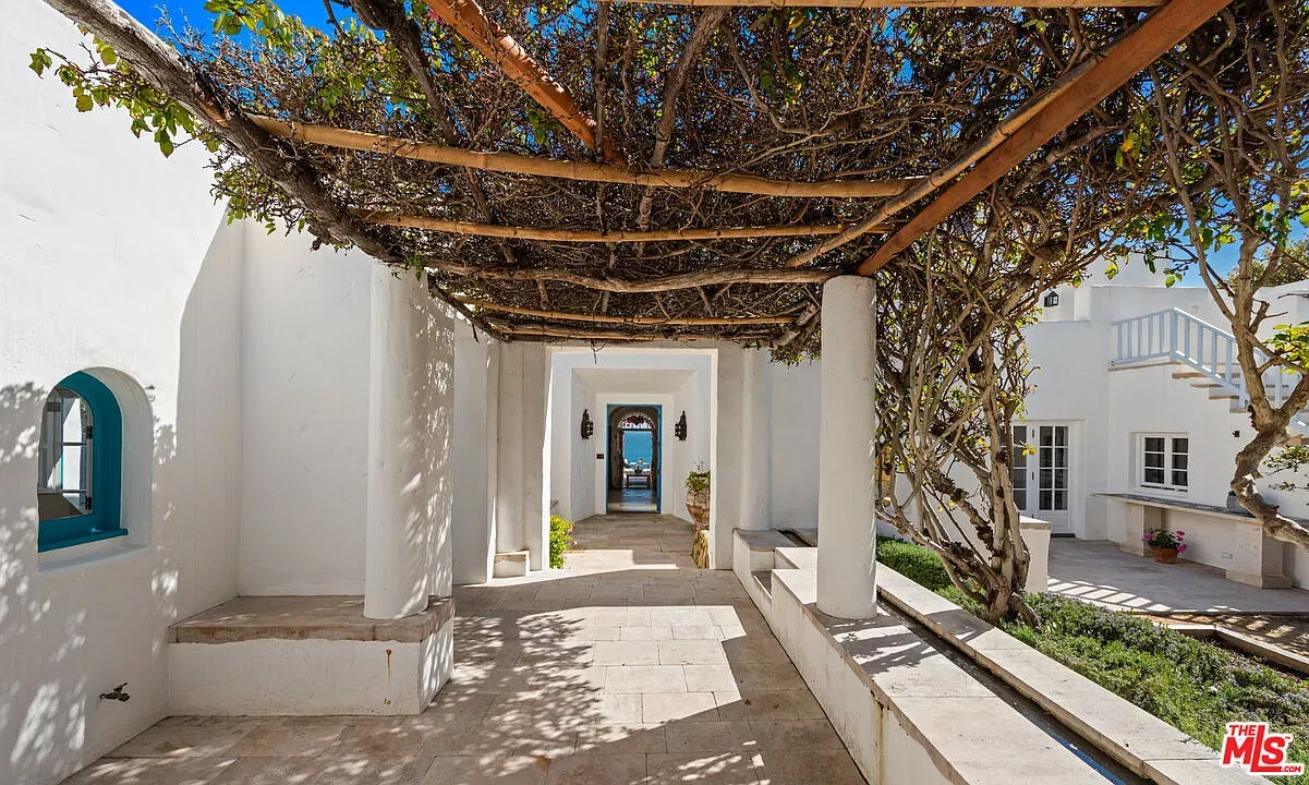 Open-air hallway with white stucco. Light just pours through. Anyone else want coffee?