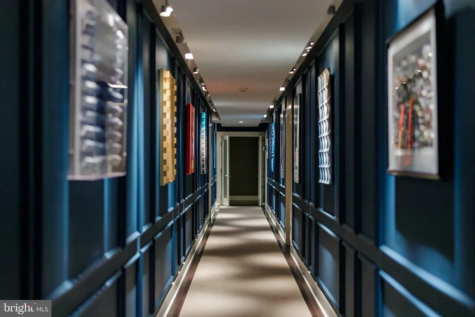 Navy paneled hall with soft gray carpet. Dramatic but comfy.