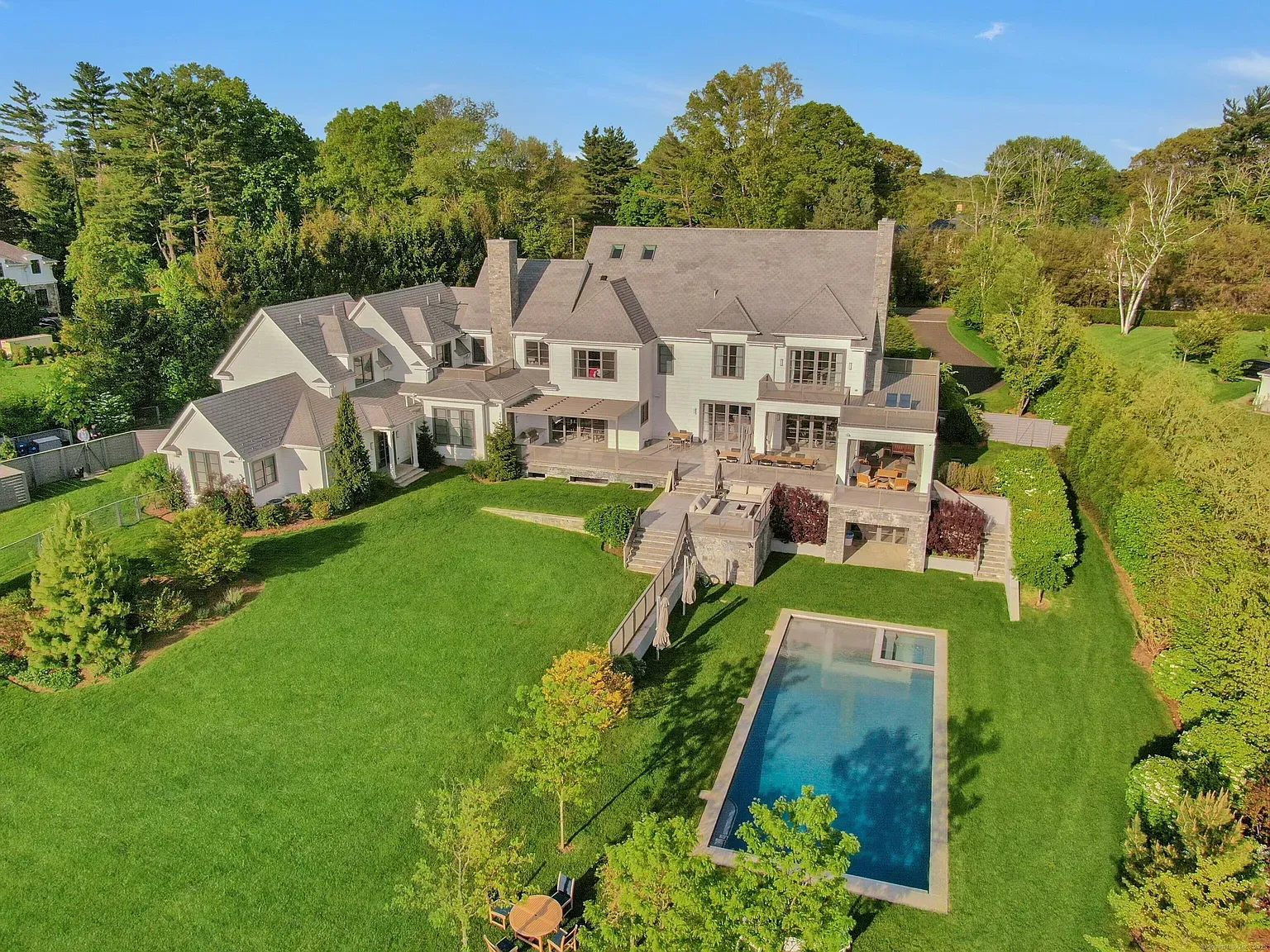 Wide shot—modern massing in the trees, all those sloped roofs stacking.