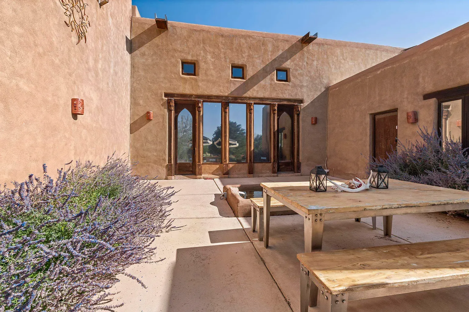 Sun and shadow on those smooth walls. Quiet courtyard energy.