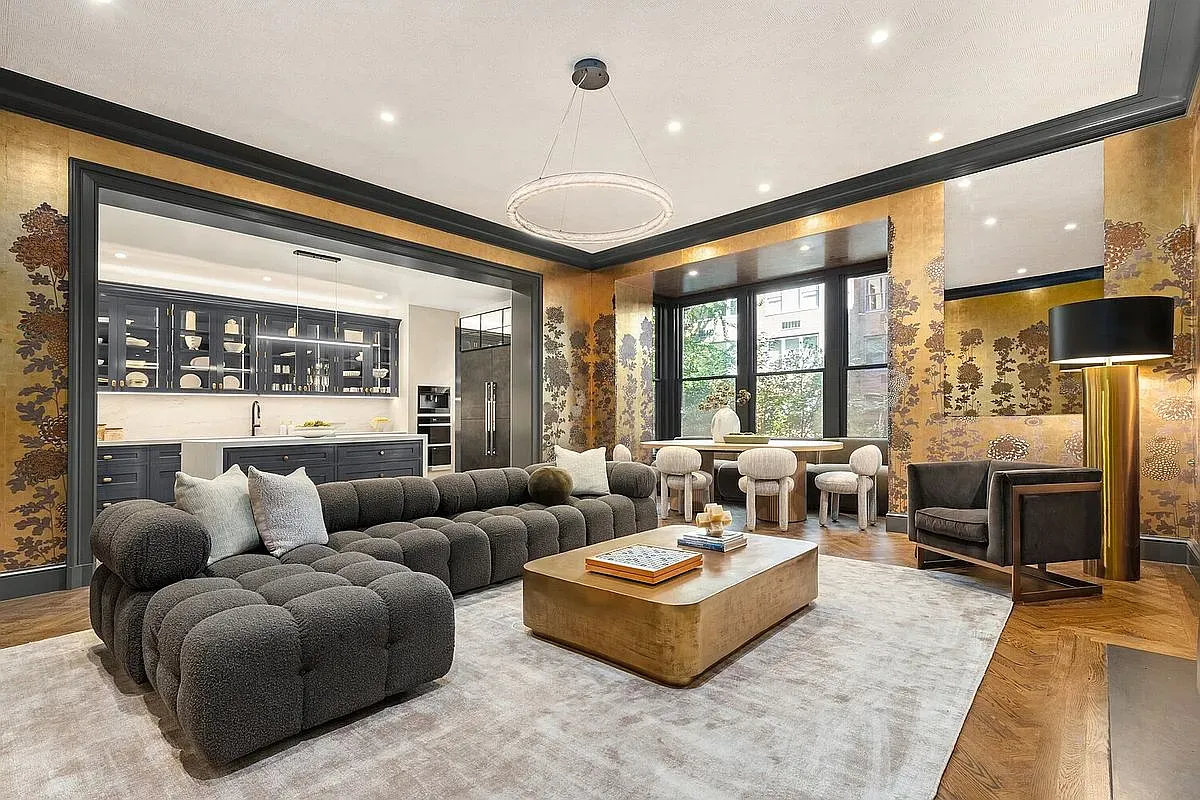 And then this cozy cave—rounded charcoal sofa, chunky wood table. I’m into it.
