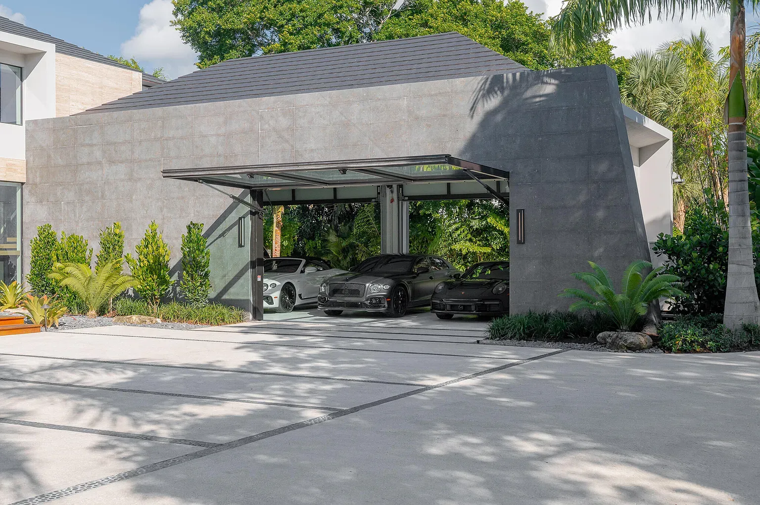 Angular concrete carport looks a spaceship landed. Low-key love the roofline.