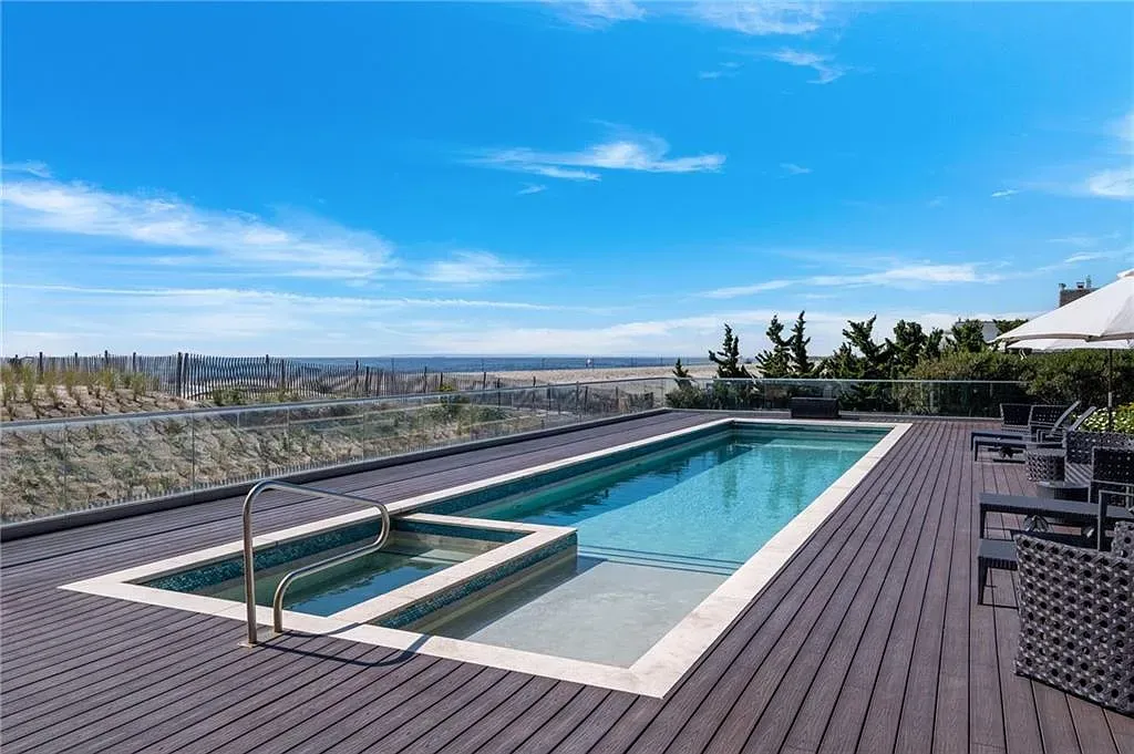 Backyard flex. pool with built-in spa, dark deck. Yes please.