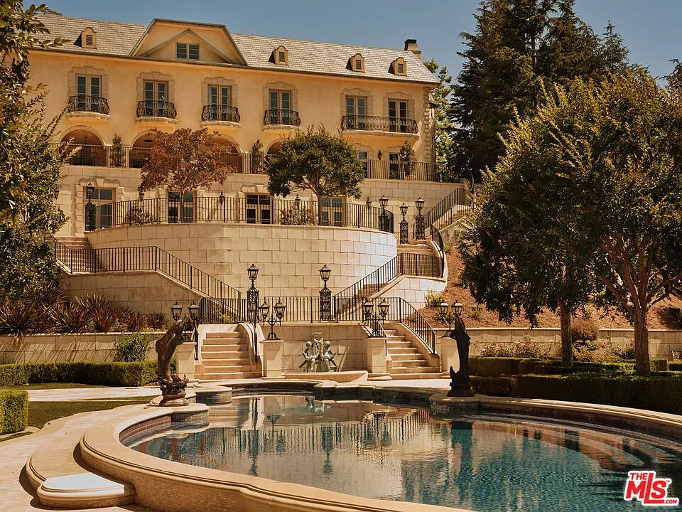 Here's the front — beige stone and fancy iron balconies. Kinda timeless, honestly.