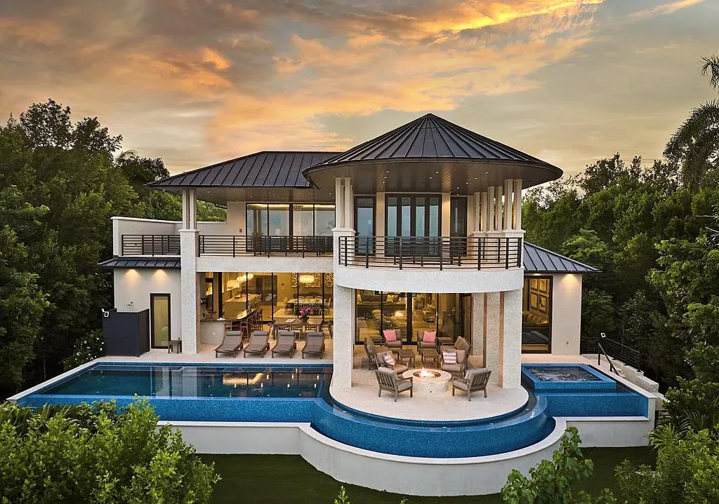 Round villa flexing a dark metal roof against white stucco. Kinda spaceship chic.
