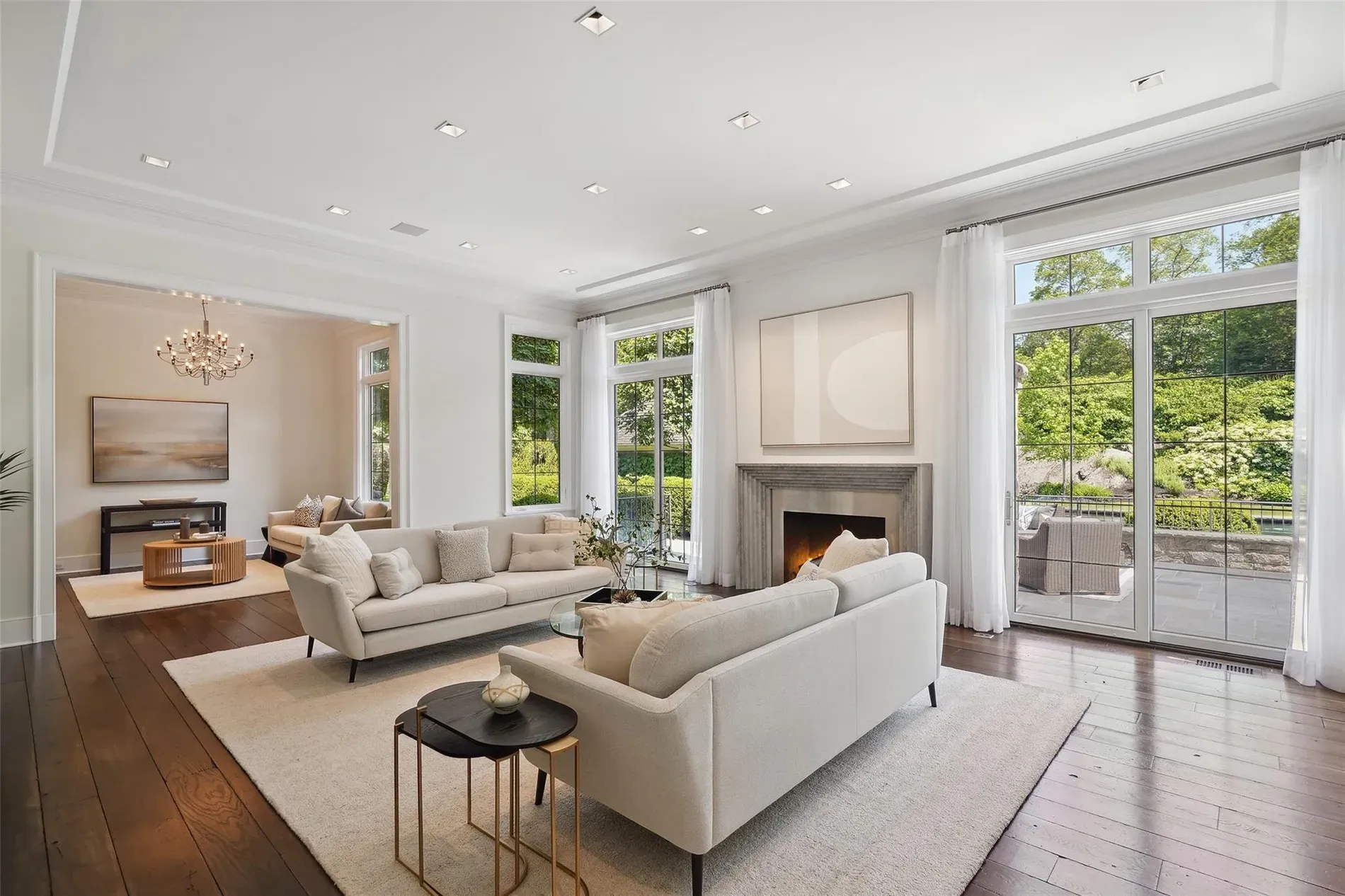 Neutral living room, sheer drapes, daylight everywhere. Cozy without trying too hard.